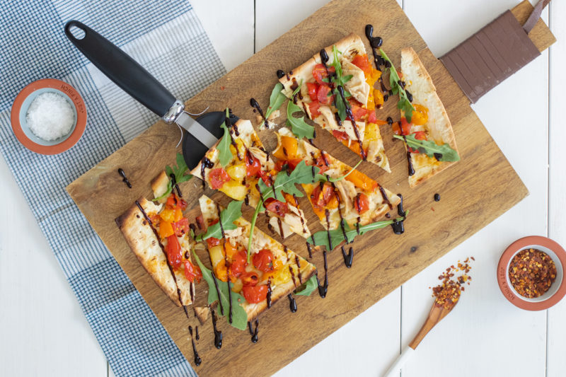 Slices of Ocean's Tuna Flatbread on a wooden board