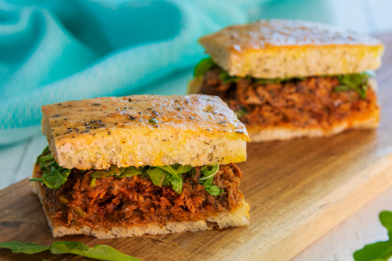 2 Savoury High Protein Italian Tuna Focaccias on a wooden board